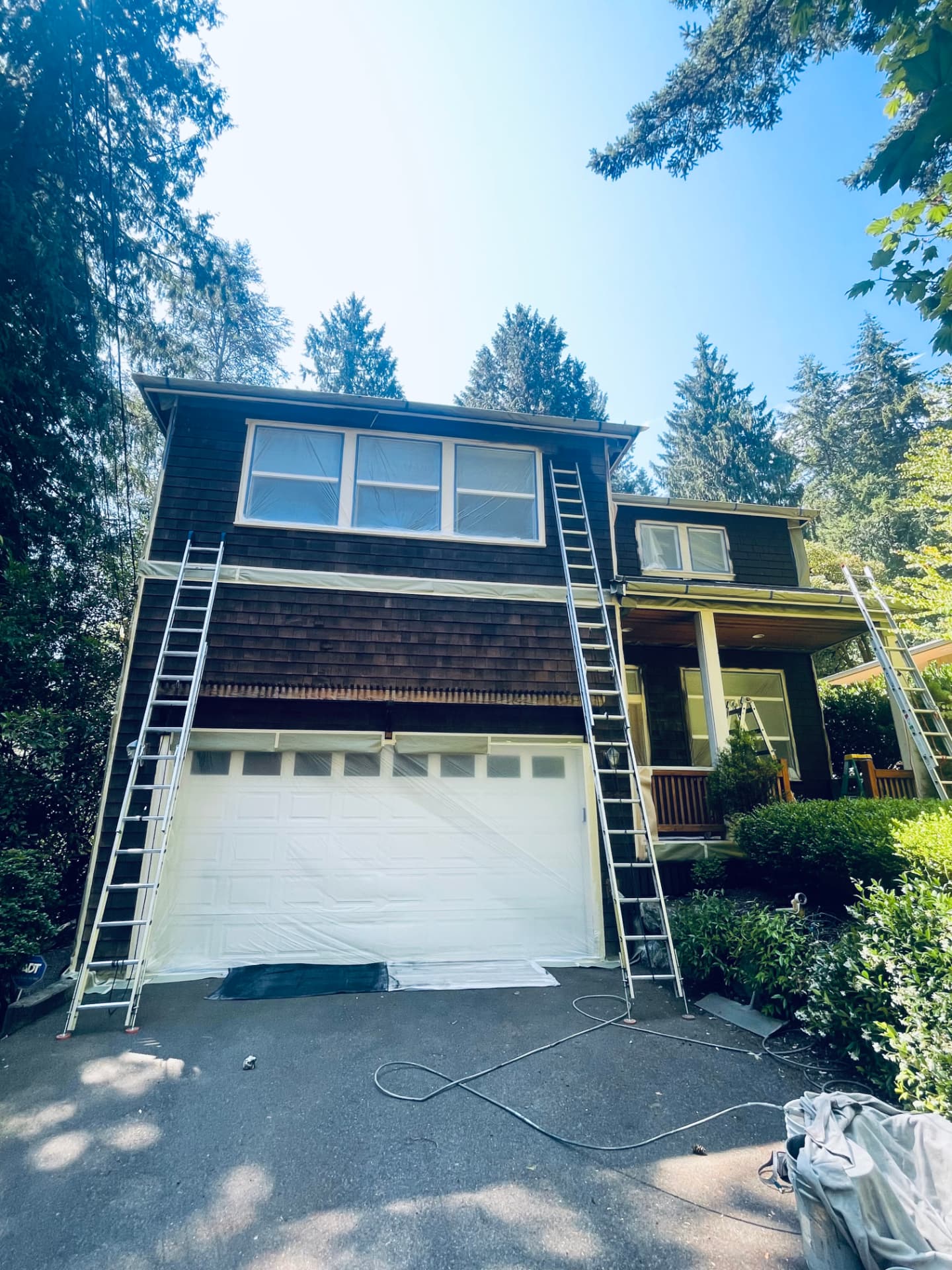 Two-story house with original brown siding before the exterior repaint.